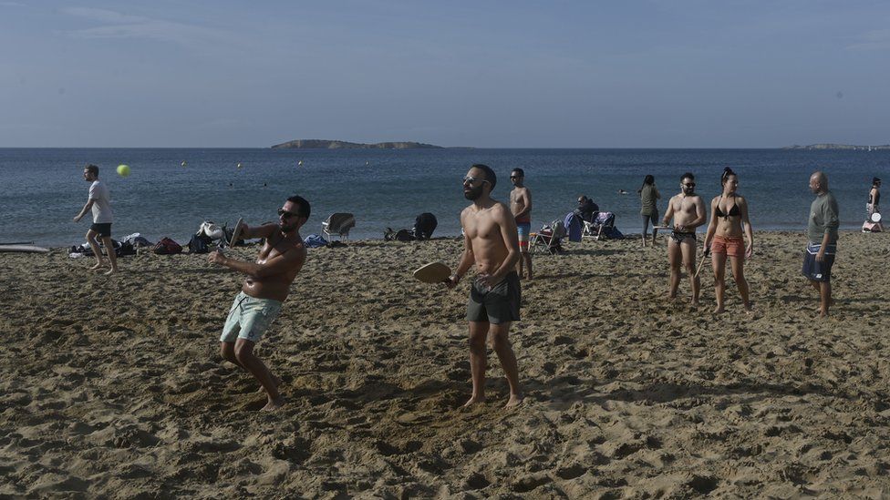 People play at a beach near Athens