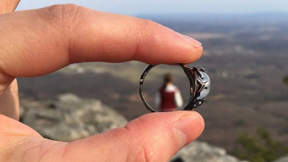 A close up of the ring, with Meg in the far distance seen through the middle of it