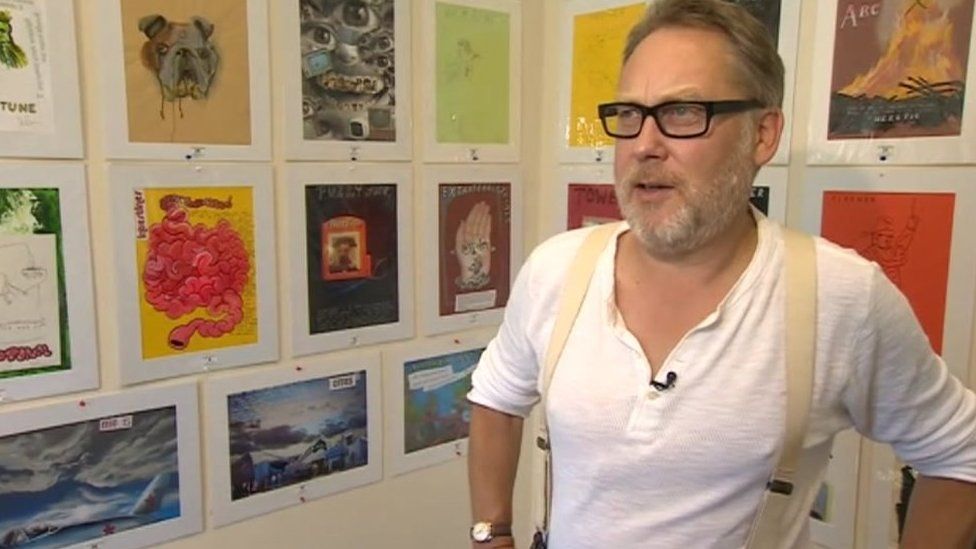 Vic Reeves with his artworks