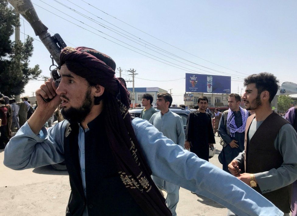 A member of Taliban forces inspects the area outside Hamid Karzai International Airport in Kabul