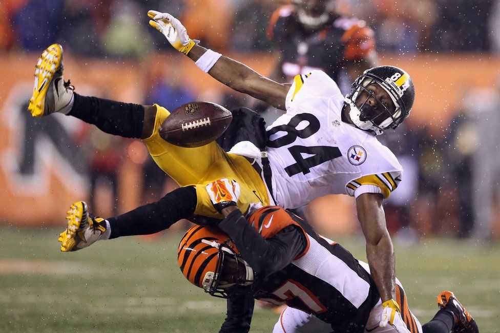 A Cincinatti Bengal player crunches into a Pittsburgh Steelers catcher