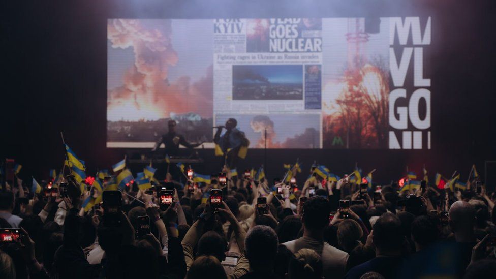 A crowd watches TVORCHI perform at a club in Lviv