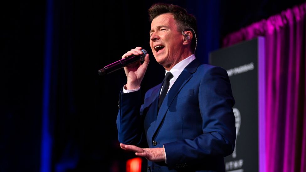 Rick Astley pictured performing in 2022