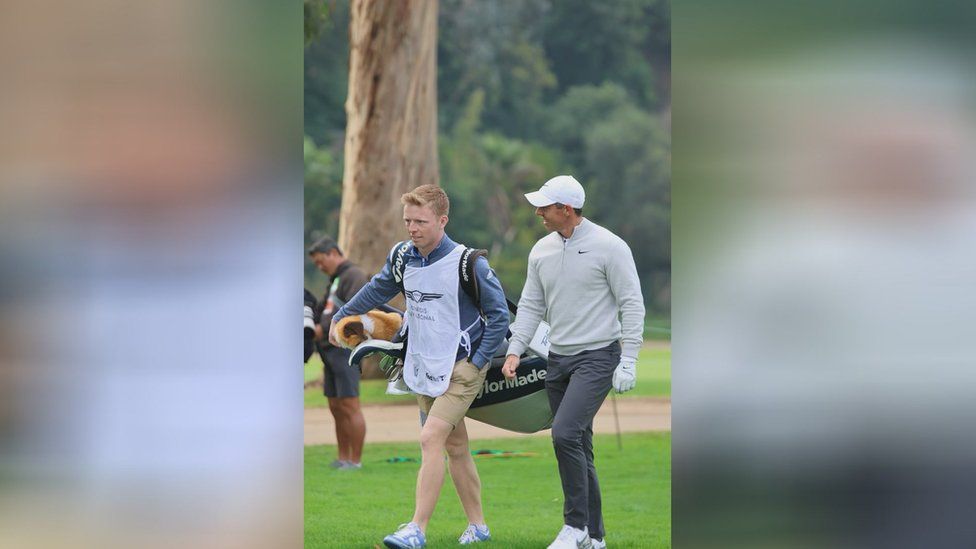 Charlie Cooley on the golf course with Rory McIlroy