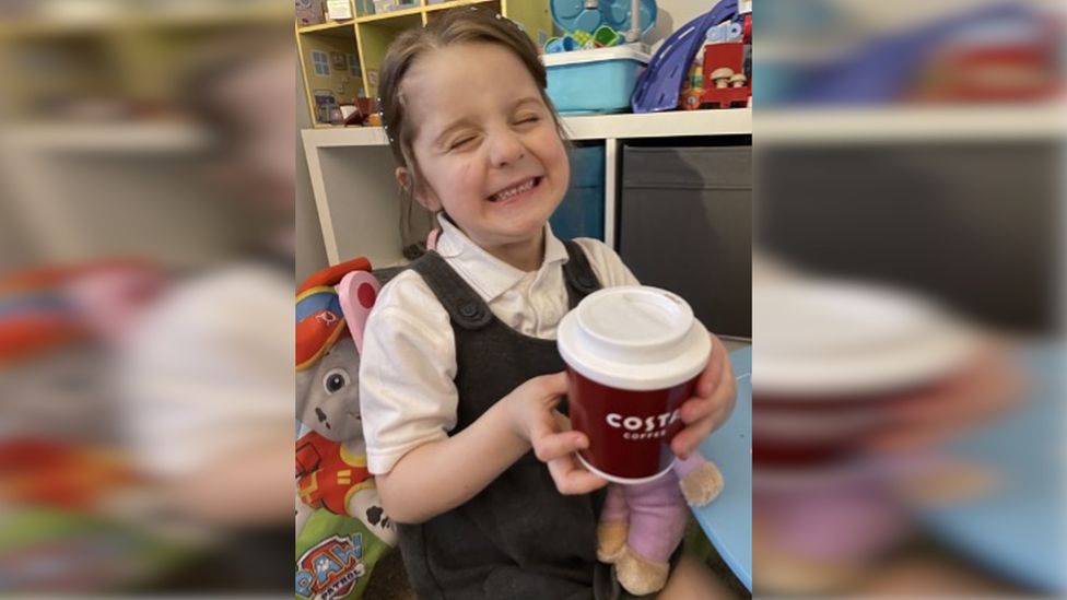 Grace Fisher, five, with a hot chocolate in a takeaway cup