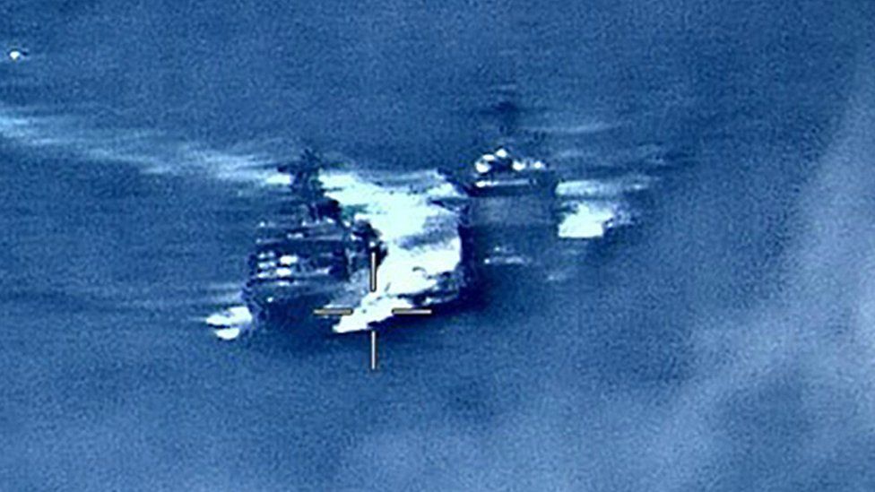 US Navy image on June 7, 2019, shows the Russian anti-submarine ship Admiral Vinogradov (L) sailing close to the USS Chancellorsville