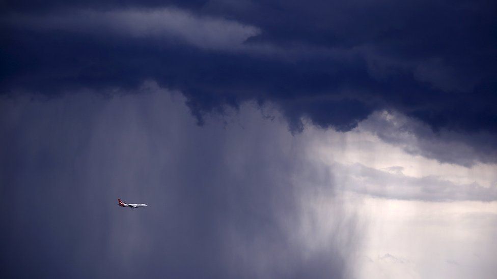 Plane flies through storm clouds