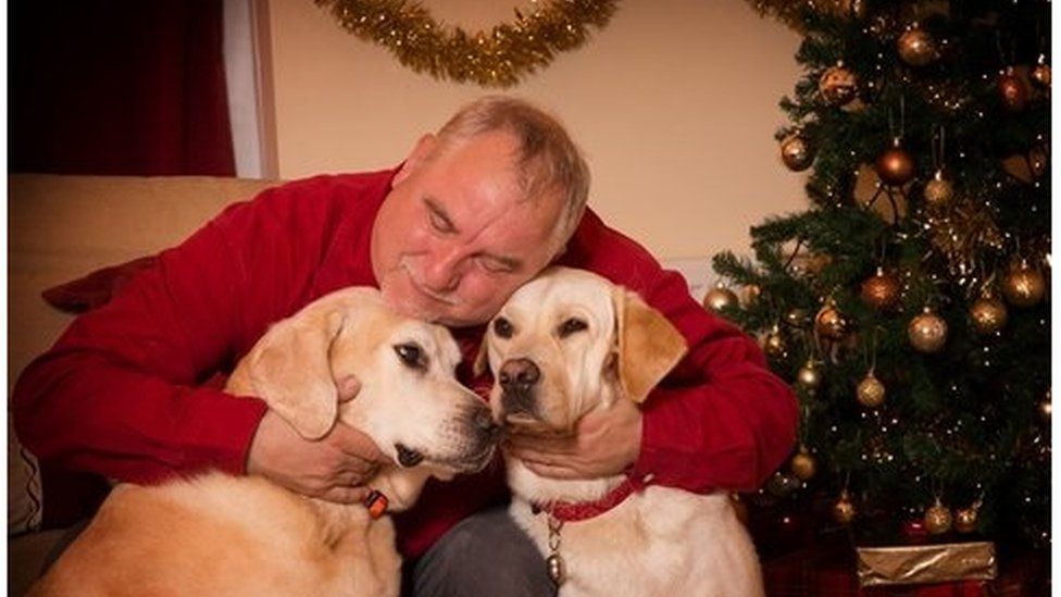 Dave Kemp with guide dogs Chad and Quince