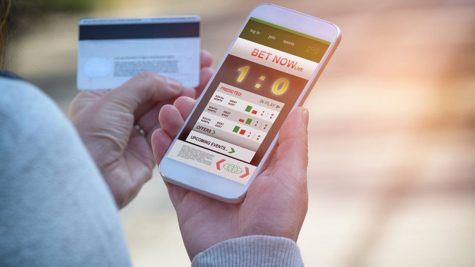 Man gambling on mobile phone