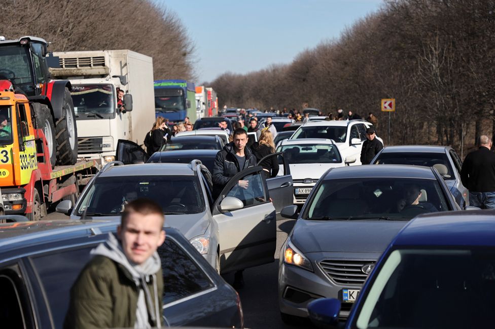 People wait in a traffic jam as they leave the city of Kharkiv, Ukraine, 24 February 2022
