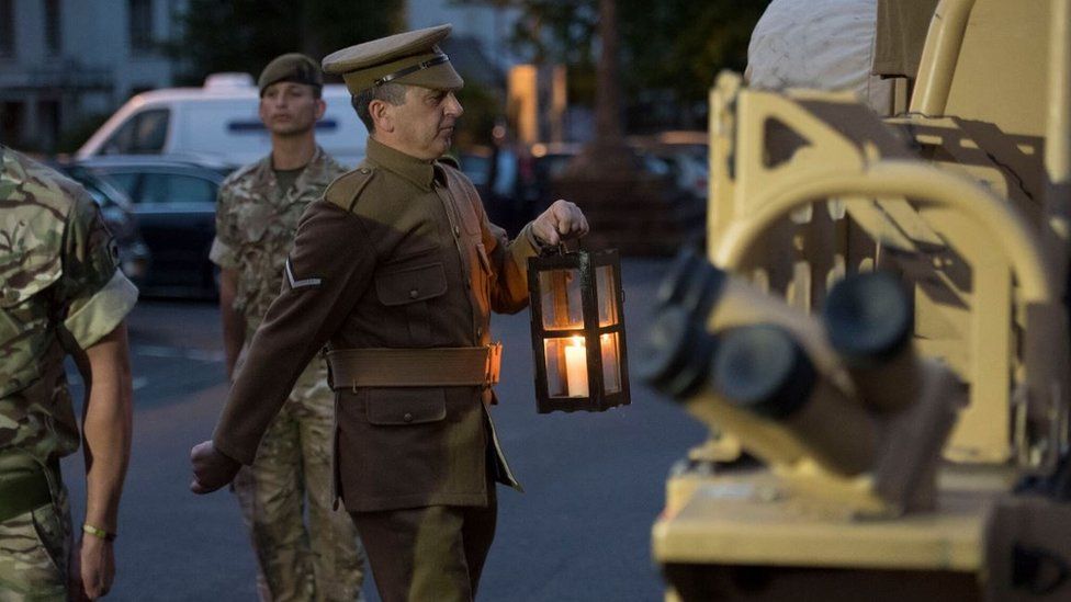 The lit candle being take to the Welsh National War Memorial, Cardiff
