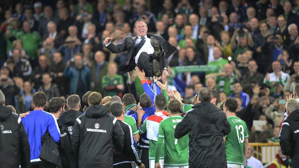 Manager Michael O'Neill was hoisted in the air by his overjoyed team
