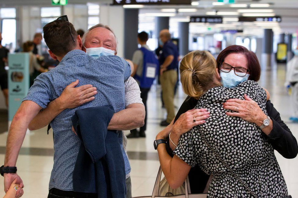 Passengers are greeted by loved ones as a flight from Sydney arrives at Perth Airport on December 8, 2020 in Perth, Australia. Western Australia has eased its COVID-19 border restrictions.