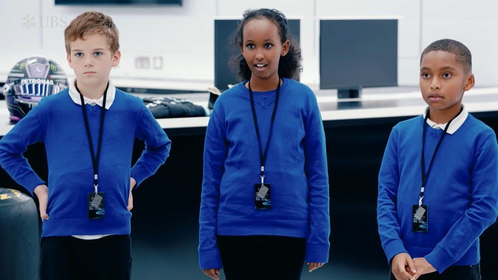 The three children on the Mercedes tour when they met Lewis Hamilton
