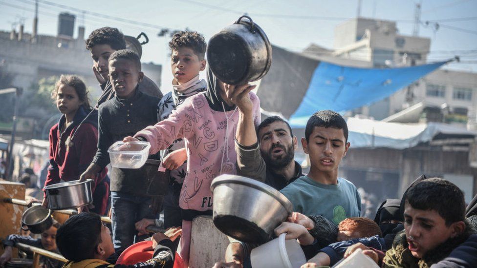 Palestinians queuing for food in Rafah