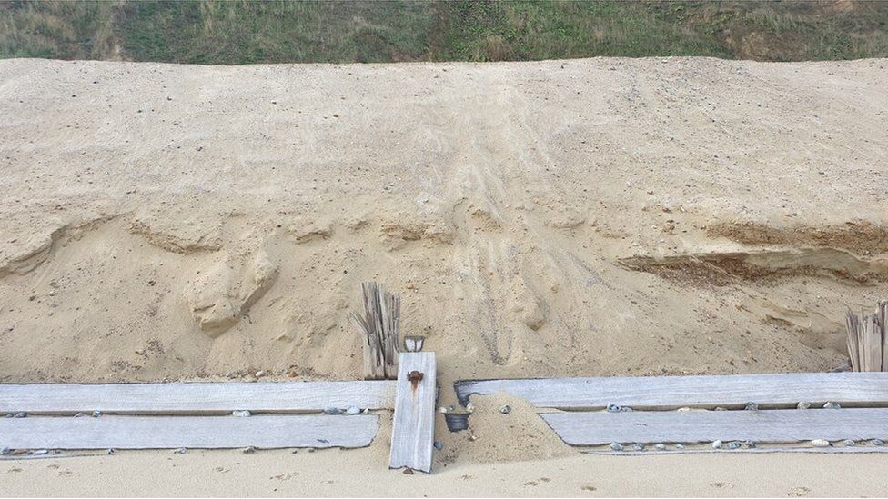 Sand is piled up behind wooden defences at Mundesley