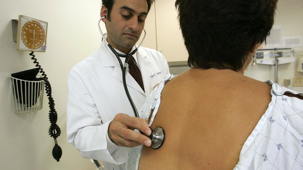 A doctor examines a patient in San Francisco, California