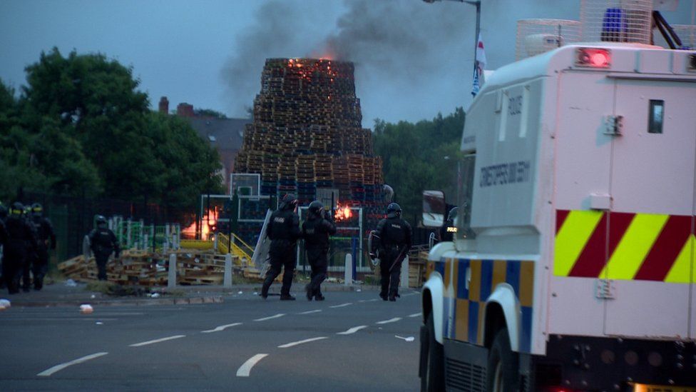 Police officers in riot gear at the Bloomfield walkway bonfire