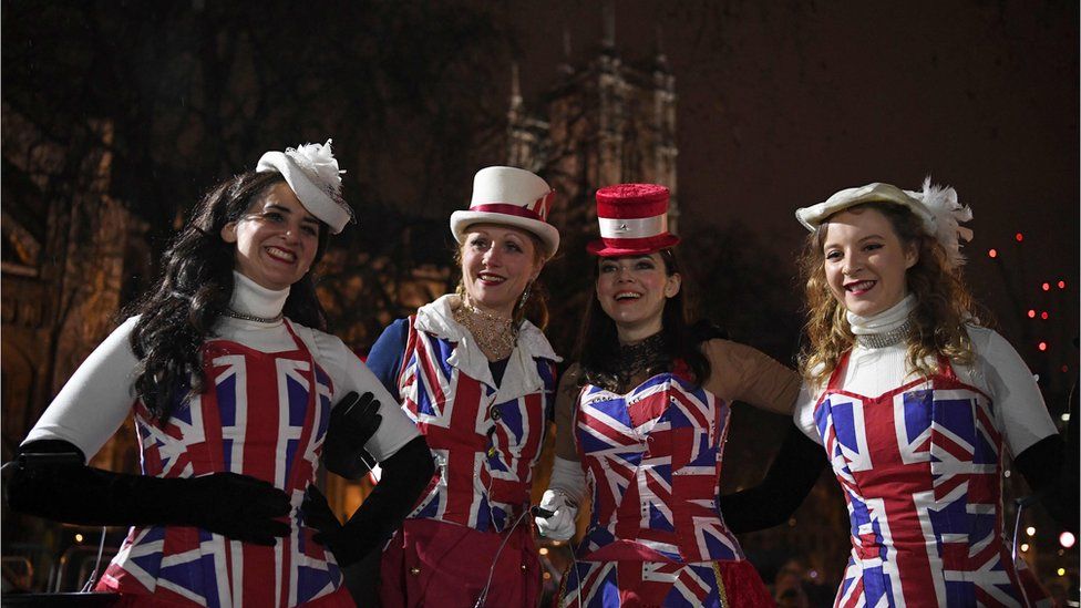 Pro-Brexit supporters don Union Jack-themed clothes pose for a photograph in Parliament Square, the venue for the Leave Means Leave Brexit Celebration.