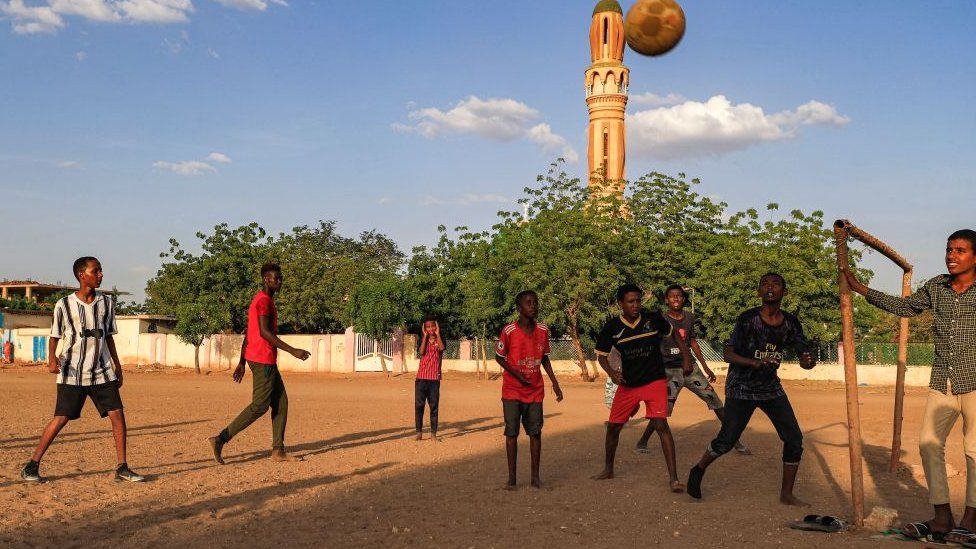 Young people play football in the Sahafa neighbourhood in the south of Khartoum, Sudan - 1 November 2021