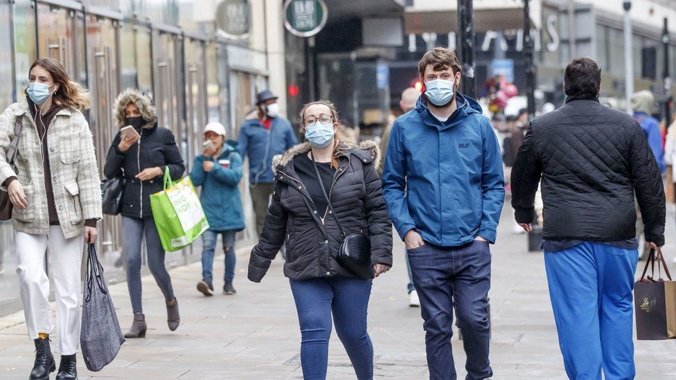 People wear face coverings in Manchester City Centre