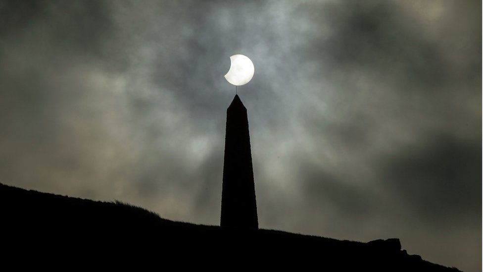 A partial solar eclipse visible over Stoodley Pike, a 1,300-foot hill in the south Pennines in West Yorkshire