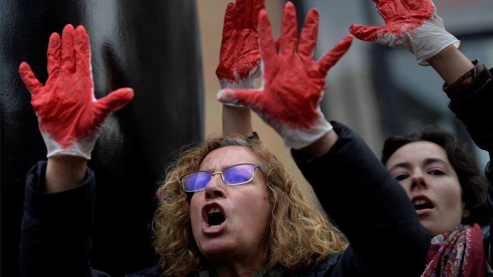 People shout slogans during a protest after a Spanish court condemned five men accused of the group rape of an 18-year-old woman, in Oviedo