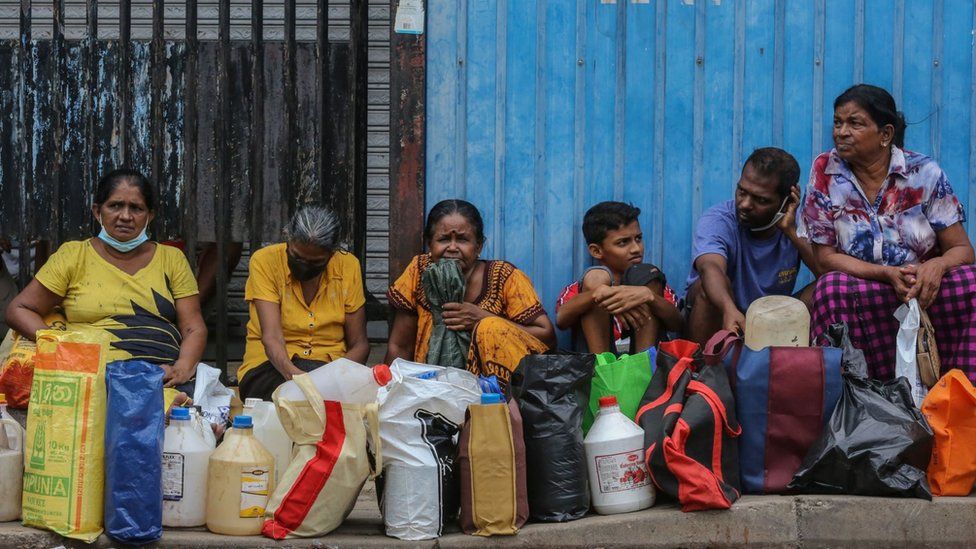 People wait to buy kerosene at a gas station amid a fuel shortage in Colombo, Sri Lanka.
