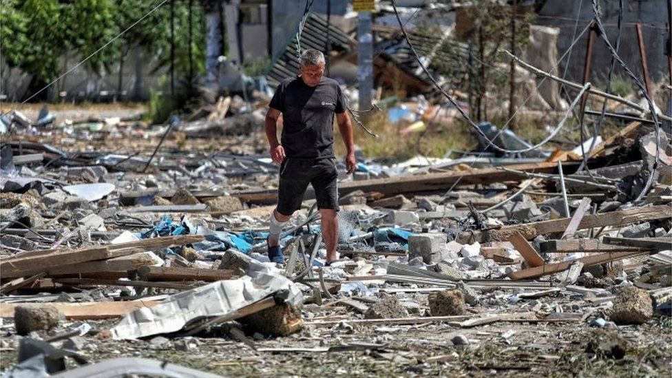 A man walks among destroyed buildings in Zatoka, Odesa region, following what Ukraine says was a massive Russian missile strike. Photo: 26 July 2022