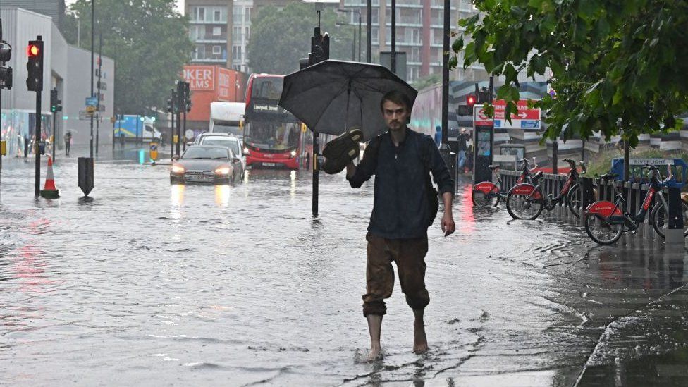 Pedestrian walking through floodwater