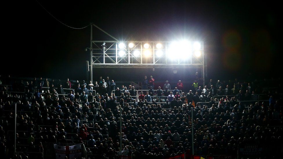 Stadium light shining over audience