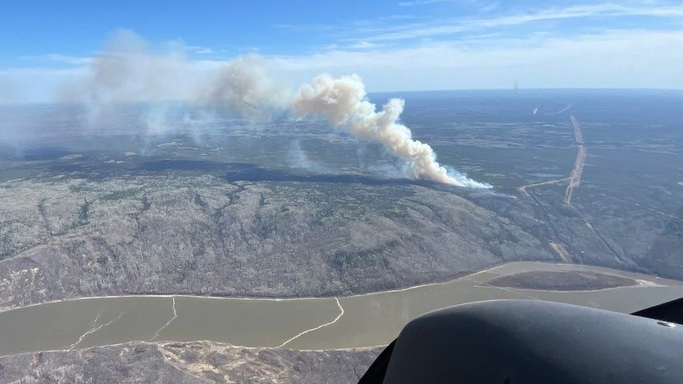 Smoke billows from burning wildfire