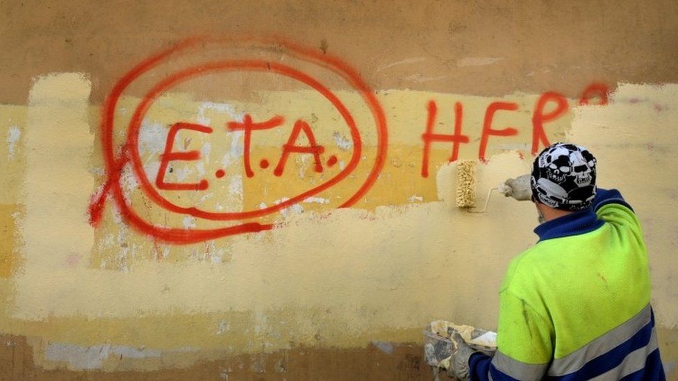 A municipal worker paints over graffiti reading "ETA, The People Are With You" the day after Basque separatist group ETA announced a definitive cessation of armed activity, in the Basque town of Guernica, Spain (21 October 2011)