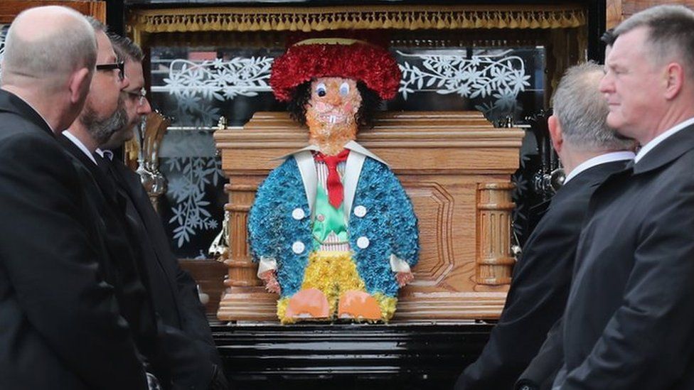 Sir Ken Dodd's coffin was adorned with a decoration based on one of his Diddy Men