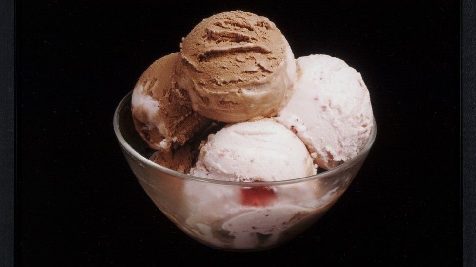 A bowl of chocolate and strawberry ice cream