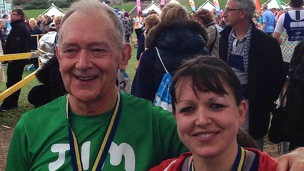 Jim Tassell smiles with a medal astir   his cervix  aft  participating successful  a race