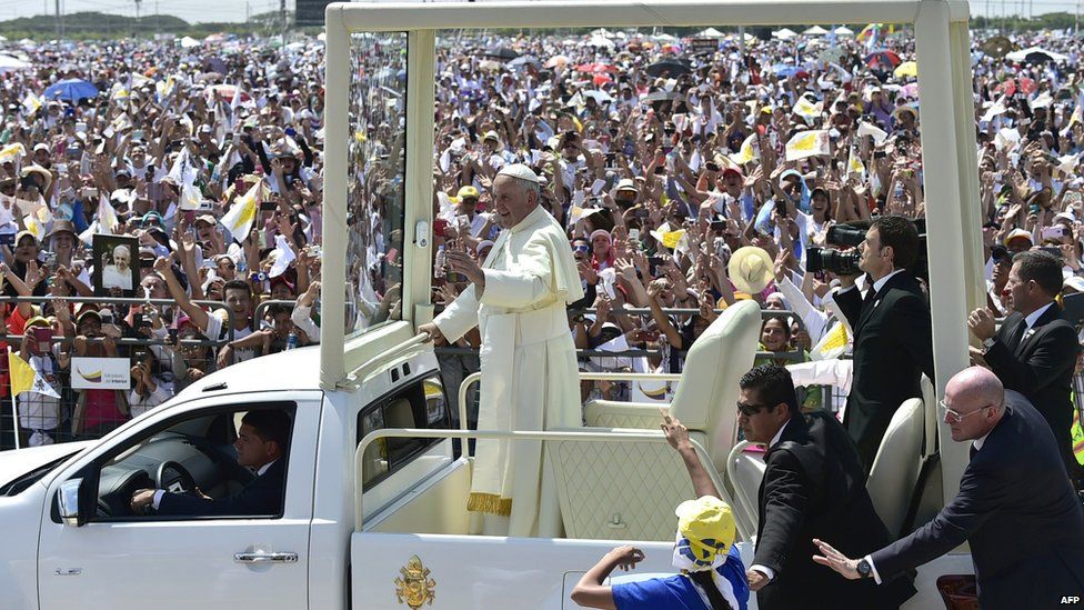 Pope Francis waves at the crowd of faithful gathering for an open-air mass at Samanes Park in Guayaquil, Ecuador, on July 6, 2015.
