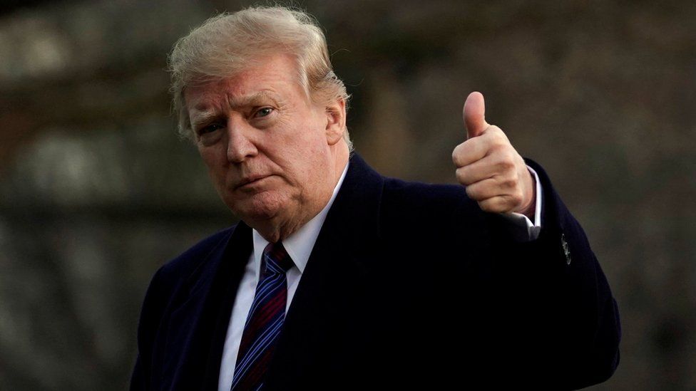 President Donald Trump giving a thumbs up gesture as he returns fro his annual physical exam