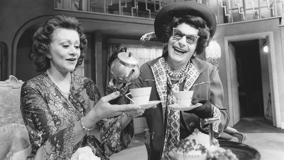 Dame Edna Everage takes tea on stage with the actress Dame Joan Plowright