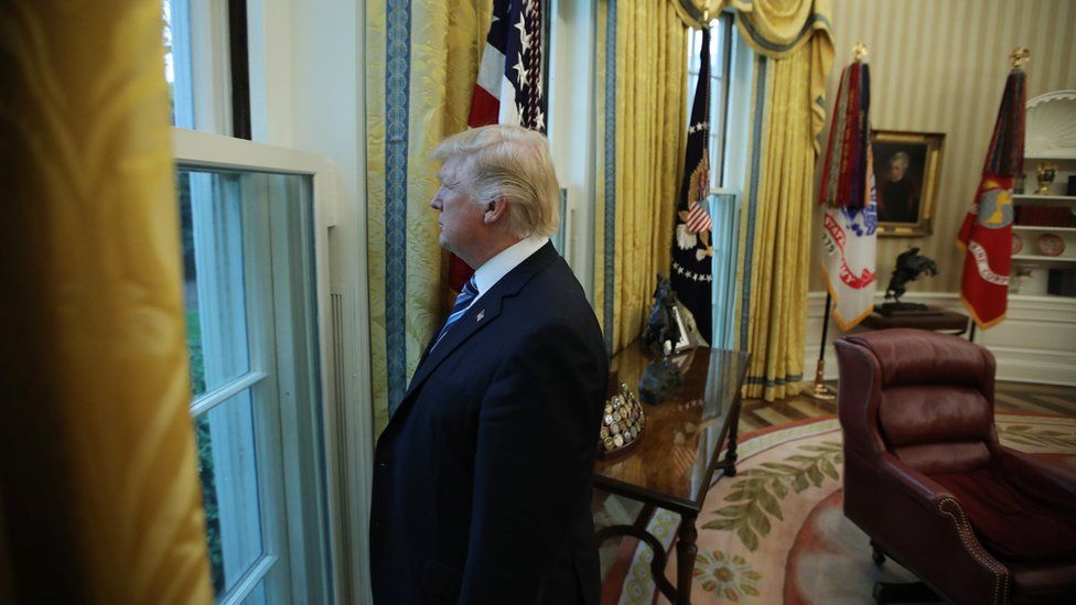 US President Donald Trump looks out a window of the Oval Office following an interview with Reuters at the White House in Washington, 27 April