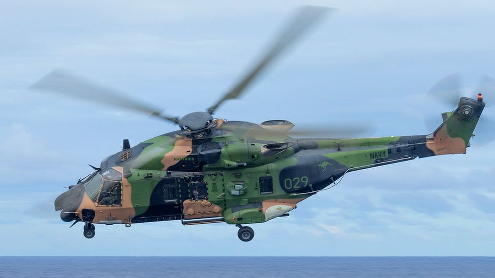 A handout file photo made available on 29 July 2023 by the Australian Defence Force (ADF) shows an Australian Army MRH-90 Taipan helicopter conducting flying serials during a ship's transit to Vanuatu, 23 July 2020