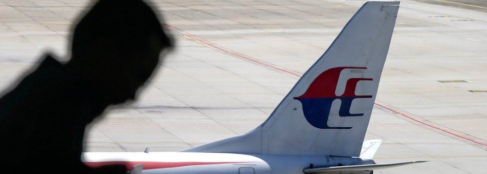 A file picture dated 17 July 2016 shows a passenger walking past a Malaysia Airlines aircraft within a viewing gallery of the Kuala Lumpur International Airport (KLIA) in Sepang, outside Kuala Lumpur, Malaysia
