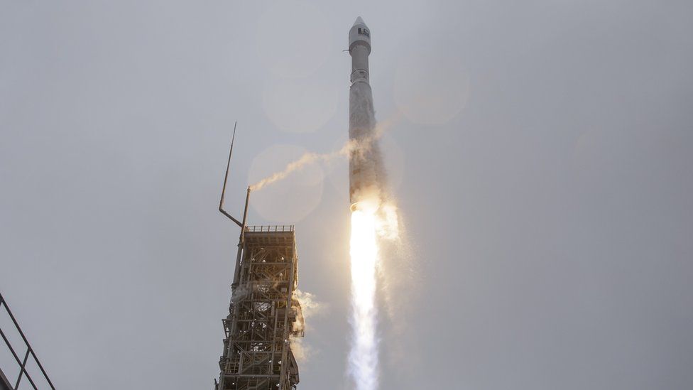 The rocket and satellite being launched