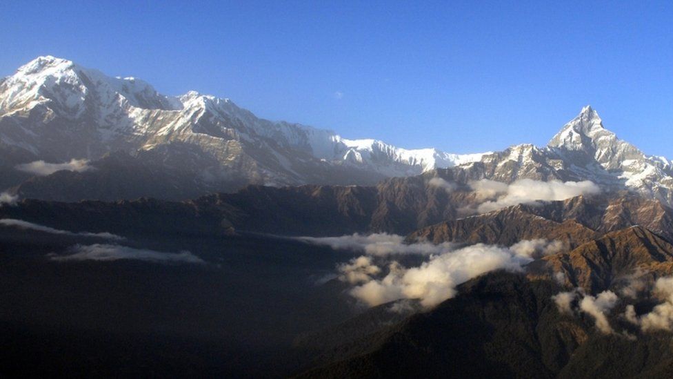 The Himalayan Mountains pictured from Mount Machhapuchre (R) and Mount Annapurna from Pokhara, west of Kathamndu