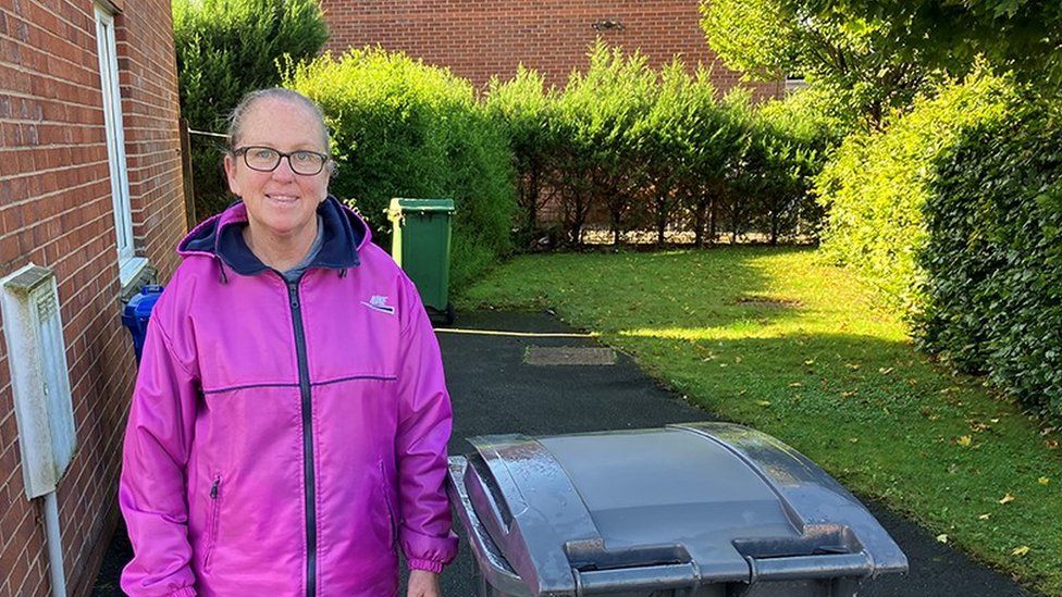 Gayle Evans in her garden with her bin