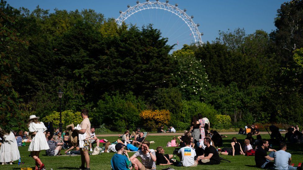Members of the public enjoy the sun in St James Park on Sunday