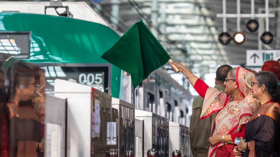 Bangladeshi Prime Minister Sheikh Hasina holds a green flag at the opening of the metro rail