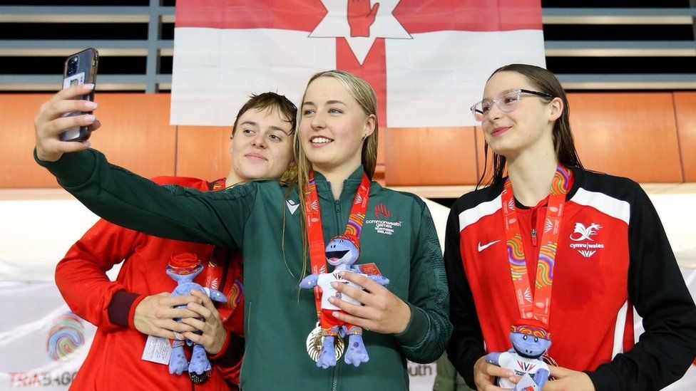 Ellie McCartney taking a selfie with two other competitors