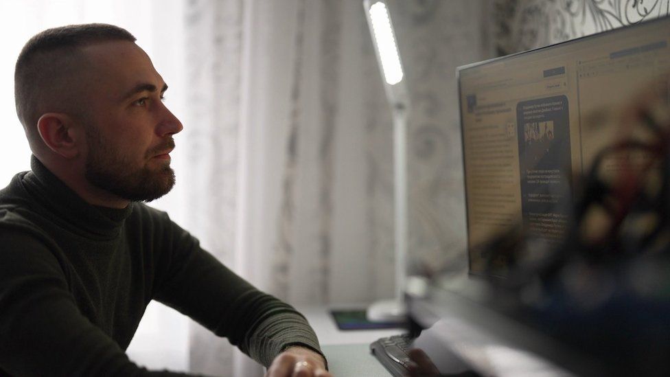 Oleksandr, seated at his computer