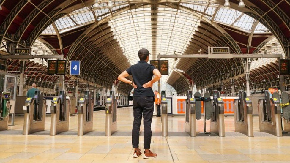 Person stands at a deserted Paddington Station